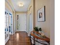 Welcoming entryway with hardwood floors, white trim, and stylish decor, creating a warm and inviting ambiance at 12015 Blackwell Way, Parker, CO 80138