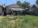 The backyard view shows an overgrown yard with an aging, covered patio at 1415 Raleigh St, Denver, CO 80204