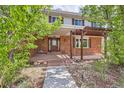 Charming brick home with covered entryway and pergola, stone steps and walkway at 6646 S Fundy Ct, Centennial, CO 80016
