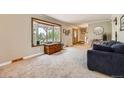 Inviting living room with neutral paint, new carpet, bay window with seating and ample natural light at 6646 S Fundy Ct, Centennial, CO 80016