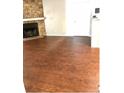 An open living room area with hardwood floors and a stone fireplace at 18193 E Kentucky Ave # 201, Aurora, CO 80017