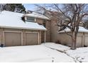 Brick townhouse with attached two-car garage, snow covered at 1470 S Quebec Way # 83, Denver, CO 80231