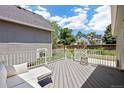 A view of the outdoor deck and backyard featuring plenty of space for lounging and entertaining at 4786 S Yampa St, Aurora, CO 80015