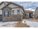 Home features stone and siding accents, a two car garage, and covered entry at 804 W 128Th Pl, Westminster, CO 80234