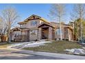 Charming two-story house boasting a stone accent exterior, an inviting entryway, and well-maintained landscaping at 6928 S Eaton St, Littleton, CO 80128