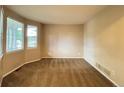 Bedroom with neutral carpet and multiple windows offering ample natural light at 10027 Sylvestor Rd, Highlands Ranch, CO 80129
