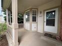 Inviting front porch with neutral paint and a covered entryway at 10027 Sylvestor Rd, Highlands Ranch, CO 80129