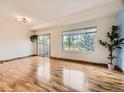 Spacious living room with wood floors, large windows and access to the back yard at 12265 E 2Nd Dr, Aurora, CO 80011