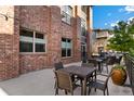 Community patio with tables and chairs for residents to enjoy at 155 S Monaco Pkwy # 114, Denver, CO 80224