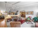 Bright living room with vaulted ceilings, neutral decor, and seamless flow to dining area at 4621 S Perry Way, Denver, CO 80236