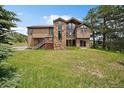 Beautiful exterior featuring a stone accent, large windows, and wood siding at 7082 Silverhorn Dr, Evergreen, CO 80439