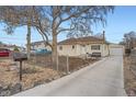 Charming single-story home with fenced front yard, exterior view at 1010 S Newton St, Denver, CO 80219