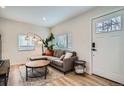 Cozy living room with hardwood floors, comfortable seating, and ample natural light at 1010 S Newton St, Denver, CO 80219