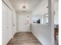 Bright entryway with wood flooring, large front door with sidelights, and coat closet at 14867 E Pacific Pl, Aurora, CO 80014