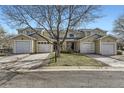 Street view of townhomes with attached garages and well-maintained lawns at 7822 South Kittredge Circle, Englewood, CO 80112
