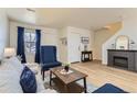 Comfortable living room with a fireplace, wooden floors, and blue accents at 7822 South Kittredge Circle, Englewood, CO 80112