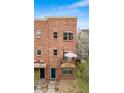 Multi-level brick home featuring private balconies with views of the community at 5428 Zephyr Ct, Arvada, CO 80002