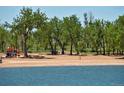 Lakeside beach area for swimming and recreation with picnic tables and playground equipment at 2141 S Irvington St, Aurora, CO 80018