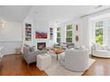 Bright living room with a fireplace, stylish decor, and hardwood floors providing a modern look at 2950 E 17Th Ave, Denver, CO 80206