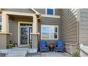 Inviting covered front porch with seating offers a cozy welcome to this charming home at 3893 Ute Mountain Trl, Castle Rock, CO 80109