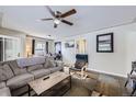 Cozy living room with a comfortable couch and a ceiling fan at 1700 W Stoll Pl, Denver, CO 80221