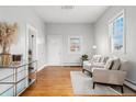 Bright living room with hardwood floors, neutral walls, and comfortable seating near a large window at 5123 Milwaukee St, Denver, CO 80216