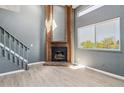 Cozy living room with a decorative brick fireplace and ample natural light at 19192 E Wyoming Pl # 206, Aurora, CO 80017