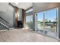 Vaulted living room with a fireplace and sliding glass doors to the deck at 19192 E Wyoming Pl # 206, Aurora, CO 80017