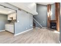 Bright open living room with a brick fireplace, light floors and high ceilings at 19192 E Wyoming Pl # 206, Aurora, CO 80017