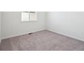 Simple bedroom with neutral carpeting and a window at 3826 N Elk St, Aurora, CO 80019