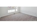 Bright bedroom with neutral carpeting and large window at 3826 N Elk St, Aurora, CO 80019