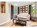 Cozy living room with hardwood floors, natural light, and decorative wall art at 4965 Huntwick Pl, Highlands Ranch, CO 80130