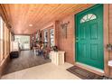 Hallway featuring wood plank walls, a tile floor and a green exterior door with a decorative half moon window at 85 Revett Dr # 15, Breckenridge, CO 80424