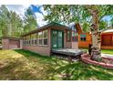 Exterior view of this home, featuring a well-maintained yard and peaceful outdoor living space at 85 Revett Dr # 15, Breckenridge, CO 80424