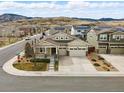 Aerial view of the house showcasing its location in a neighborhood with mountain views at 6013 Eldora St, Golden, CO 80403