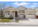 Attractive two-story home with a two-car garage, well-kept lawn, and charming front porch at 6013 Eldora St, Golden, CO 80403