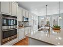 Bright kitchen with stainless steel appliances, island, and modern backsplash at 6013 Eldora St, Golden, CO 80403