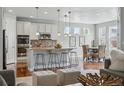 Spacious kitchen with stainless steel appliances, island seating, and hardwood flooring for entertaining at 6013 Eldora St, Golden, CO 80403