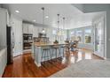 Bright, modern kitchen features an island with seating and stainless steel appliances at 6013 Eldora St, Golden, CO 80403