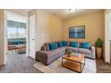 Comfortable living room features a large sectional sofa, gray carpet, and ample natural light at 20535 E 47Th Ave, Denver, CO 80249