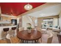 Open-concept living space featuring a kitchen, dining area, living room, and staircase at 20535 E 47Th Ave, Denver, CO 80249