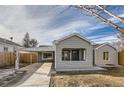 Charming craftsman home with gray siding and a carport at 2043 Elmira St, Aurora, CO 80010