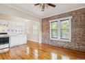 Bright living area with brick accent wall, hardwood floors, and an open layout at 1351 N Washington St # 23, Denver, CO 80203