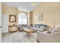 Inviting living room with natural light, tile floors, and cozy seating arrangement at 14425 E 50Th Ave, Denver, CO 80239