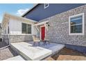 Charming front porch with stone accents and a welcoming red door, perfect for relaxing outdoors at 27593 E 1St Pl, Aurora, CO 80018