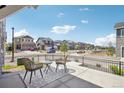 Comfortable seating area on a front porch overlooking a street with sidewalks at 27593 E 1St Pl, Aurora, CO 80018