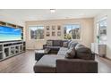 Comfortable living room with a large sectional sofa and bright windows that offer a view at 27593 E 1St Pl, Aurora, CO 80018