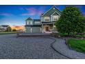 Beautiful two-story home boasts lush landscaping, a large front yard, and a welcoming porch at 881 Kirby Ct, Watkins, CO 80137