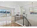 Living room with hardwood floors, fireplace, and modern staircase at 8791 Yellowcress St, Littleton, CO 80125