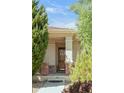 Inviting front entrance with a glass screen door and brick columns, framed by mature trees at 4519 Silver Mountain Loop, Broomfield, CO 80023